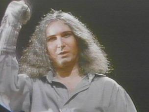 Jim Steinman in the role of Peter, raises his silver-gloved right fist