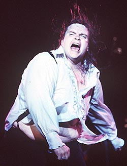 vintage 1978 photo of Meat Loaf in concert - his hair flying, his shirt parted