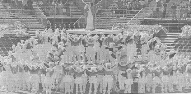 A monochrome photograph showing dozens of children performing the song When Children Rule The World, at the 1998 Winter Olympic Games, in Nagano, Japan
